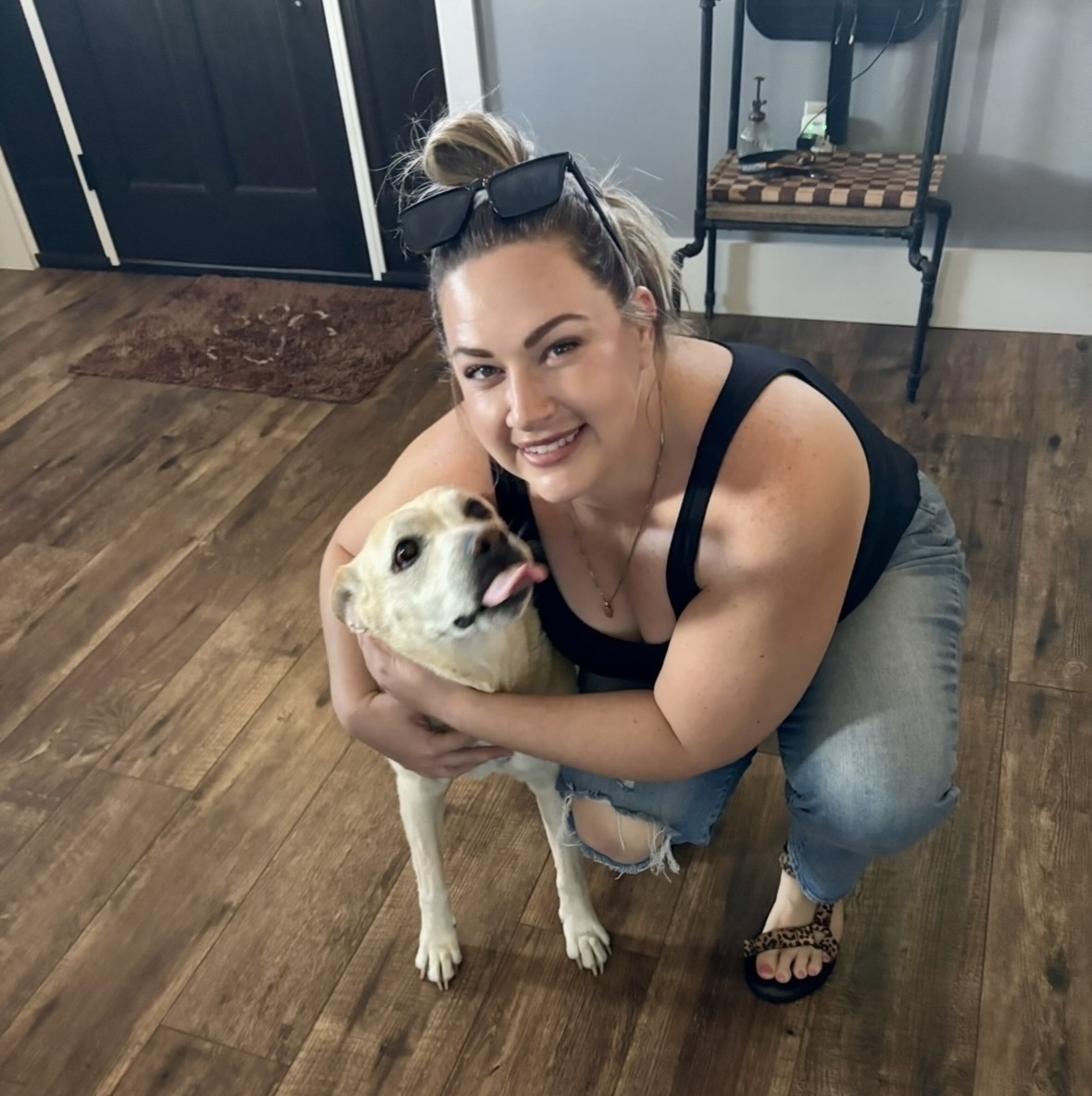 Kelly smiling with her dog Bane